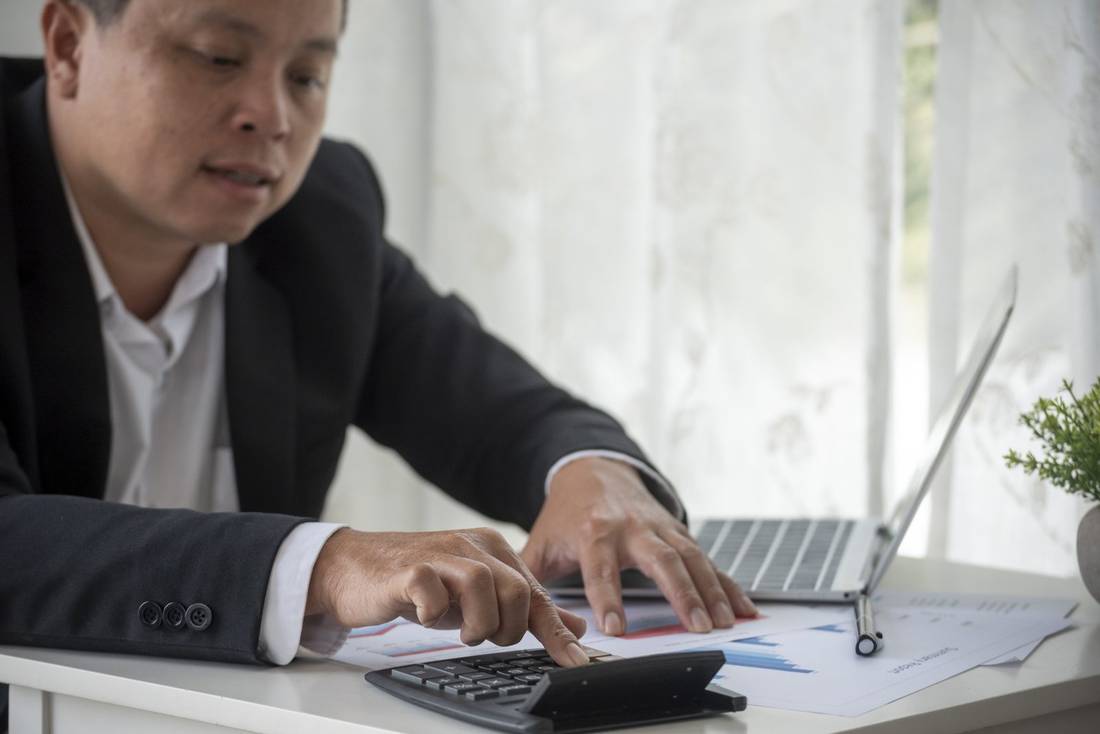 Accountant reviewing audit fees schedule for a Sdn Bhd in Malaysia